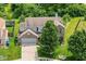Aerial view showcasing a home with a two-car garage and mature trees in a residential neighborhood at 2029 Seven Peaks Dr, Cicero, IN 46034
