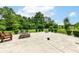 Spacious backyard with a stamped concrete patio, basketball hoop, and mature trees at 2029 Seven Peaks Dr, Cicero, IN 46034