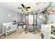 Bedroom with white crib, changing table, and a window letting in natural light at 2029 Seven Peaks Dr, Cicero, IN 46034