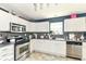 Cozy kitchen features white cabinets, stainless steel appliances, and backsplash at 2029 Seven Peaks Dr, Cicero, IN 46034