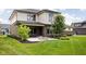 Beautiful backyard with a well-manicured lawn, patio, brick accents, and lush landscaping at 20450 Chatham Hills Blvd, Westfield, IN 46074
