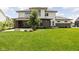 Spacious backyard featuring a covered patio, well-maintained lawn, and lush landscaping, perfect for outdoor enjoyment at 20450 Chatham Hills Blvd, Westfield, IN 46074
