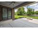 Covered patio with brick columns, overlooking a spacious backyard with a stone fire pit and lush landscaping at 20450 Chatham Hills Blvd, Westfield, IN 46074