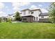 Expansive backyard with a lush green lawn, patio area, mature trees, and pristine landscaping, offering serene outdoor living at 20450 Chatham Hills Blvd, Westfield, IN 46074