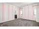 Striking bedroom featuring pink and white stripes, and a bathroom located through an open doorway at 20450 Chatham Hills Blvd, Westfield, IN 46074