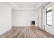 Spacious, bright bedroom with a decorative light fixture, wood-look flooring and a view into the bathroom at 20450 Chatham Hills Blvd, Westfield, IN 46074