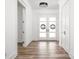 Bright foyer with wood floors and front door with decorative wreaths, and hallway at 20450 Chatham Hills Blvd, Westfield, IN 46074