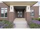 Inviting front entrance featuring double doors with decorative wreaths and manicured landscaping at 20450 Chatham Hills Blvd, Westfield, IN 46074