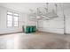 Large two car garage with storage racks, concrete flooring, and new garage door at 20450 Chatham Hills Blvd, Westfield, IN 46074