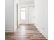 Hallway featuring stylish wood flooring and a sliding barn door with neutral-toned walls at 20450 Chatham Hills Blvd, Westfield, IN 46074