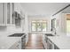 Modern kitchen with white cabinets, quartz countertops, and stainless steel appliances at 20450 Chatham Hills Blvd, Westfield, IN 46074