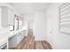 Open kitchen and hallway space with white cabinets and hardwood flooring at 20450 Chatham Hills Blvd, Westfield, IN 46074