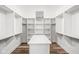 Walk-in closet with island, shelving, and hardwood flooring at 20450 Chatham Hills Blvd, Westfield, IN 46074