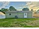 Backyard featuring a grassy area and the rear of the home at 2563 Harlan St, Indianapolis, IN 46203