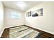 Bedroom featuring updated flooring and freshly painted neutral walls with window at 2563 Harlan St, Indianapolis, IN 46203