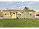 Charming single-story home with a well-manicured lawn and a bright yellow front door at 2563 Harlan St, Indianapolis, IN 46203