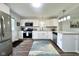 Contemporary kitchen featuring stainless steel appliances, white cabinetry, and stylish backsplash at 2563 Harlan St, Indianapolis, IN 46203