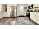 Spacious kitchen featuring stainless steel appliances, white cabinetry, and modern backsplash at 2563 Harlan St, Indianapolis, IN 46203