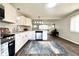 Open kitchen layout with stainless appliances, white cabinets, and a view into the living room at 2563 Harlan St, Indianapolis, IN 46203