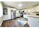 Updated kitchen with stainless steel appliances, granite countertops, and bright white cabinetry at 2563 Harlan St, Indianapolis, IN 46203