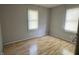 Modest bedroom with two windows and laminate flooring at 3190 S Tacoma Ave, Indianapolis, IN 46237