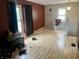 Second-floor living room with large windows, laminate flooring, and staircase access at 3190 S Tacoma Ave, Indianapolis, IN 46237