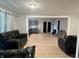 Living room featuring neutral walls and flooring with an open view of the kitchen at 3190 S Tacoma Ave, Indianapolis, IN 46237