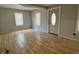 Light filled living room featuring laminate flooring and a view of the front door at 3190 S Tacoma Ave, Indianapolis, IN 46237