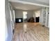 Light and airy living room featuring laminate flooring and a decorative brick accent wall at 3190 S Tacoma Ave, Indianapolis, IN 46237