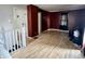 Upstairs living room with a large window and laminate flooring provides a versatile living space at 3190 S Tacoma Ave, Indianapolis, IN 46237