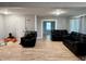 Bright living room featuring neutral paint, laminate flooring and access to other rooms at 3190 S Tacoma Ave, Indianapolis, IN 46237
