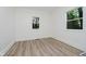 Bedroom with luxury vinyl plank flooring and natural light from two windows at 3709 Central Ave, Indianapolis, IN 46205