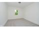 Clean bedroom with neutral carpet, white walls, and a window offering natural light at 3709 Central Ave, Indianapolis, IN 46205