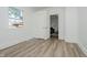 Bedroom showcasing luxury vinyl plank flooring and a view into another room at 3709 Central Ave, Indianapolis, IN 46205