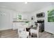 Eat-in kitchen featuring a glass table and stainless steel oven with modern white cabinetry at 3709 Central Ave, Indianapolis, IN 46205