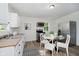 Kitchen features a stainless steel fridge, oven, microwave, white cabinets, and a glass table at 3709 Central Ave, Indianapolis, IN 46205