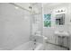 This bathroom features marble tile, a rain shower head, and sleek fixtures at 39 N Bosart N Ave, Indianapolis, IN 46201