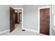 Bedroom featuring grey walls and wood trim with views into adjoining rooms at 39 N Bosart N Ave, Indianapolis, IN 46201