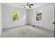 Bedroom with two bright windows and neutral carpet flooring at 39 N Bosart N Ave, Indianapolis, IN 46201