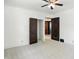 Neutral bedroom with views into the hall through open, dark-stained doors at 39 N Bosart N Ave, Indianapolis, IN 46201