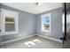 Neutral bedroom with two bright windows and neutral carpet flooring at 39 N Bosart N Ave, Indianapolis, IN 46201