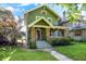 Charming home featuring a brick-and-siding facade with inviting front porch and manicured lawn at 39 N Bosart N Ave, Indianapolis, IN 46201