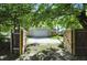 This detached two-car garage has a driveway beyond the wooden fence at 39 N Bosart N Ave, Indianapolis, IN 46201