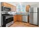 Well-lit kitchen featuring stainless steel appliances, light wood cabinets, and modern finishes at 39 N Bosart N Ave, Indianapolis, IN 46201