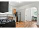 Traditional kitchen featuring stainless steel appliances, wood cabinets, and an adjacent dining area at 39 N Bosart N Ave, Indianapolis, IN 46201