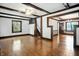 Open living room with hardwood floors, decorative trim, and access to the staircase at 39 N Bosart N Ave, Indianapolis, IN 46201