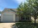 Charming single-Gathering home with well-maintained lawn, attached garage, and mature shade tree at 3929 Roundwood Dr, Indianapolis, IN 46235