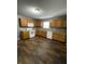 Traditional kitchen featuring wood cabinets, laminate countertops, and modern white appliances at 3929 Roundwood Dr, Indianapolis, IN 46235