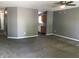 Spacious carpeted living room featuring neutral gray paint, ceiling fan, and easy access to the kitchen at 3929 Roundwood Dr, Indianapolis, IN 46235