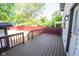 View of the stained wood deck with access to the fenced in backyard and rear entry to the home at 402 N Oxford St, Indianapolis, IN 46201